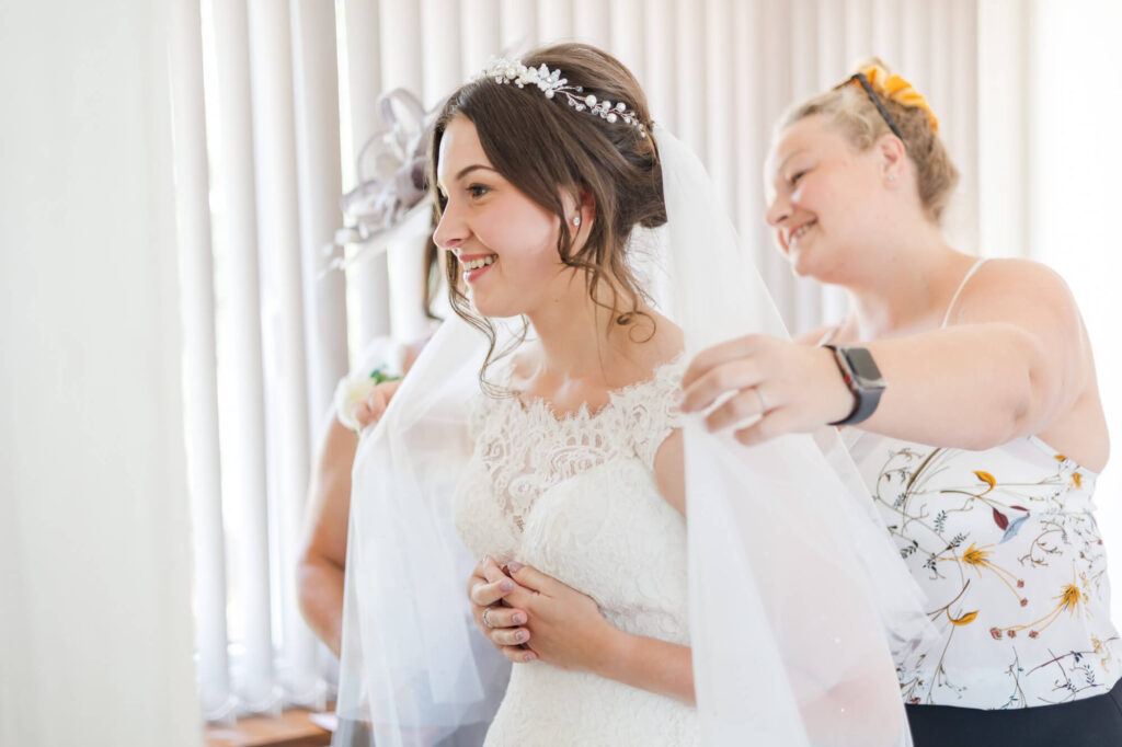 mother of bride and bride with hair and makeup artist, veil, tiara, wedding dress suffolk location